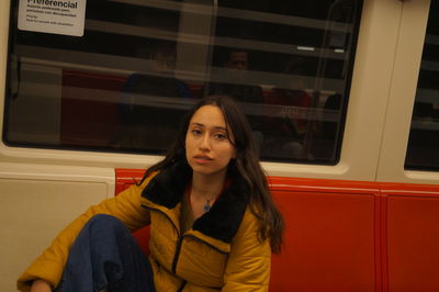Portrait of beautiful woman standing by train