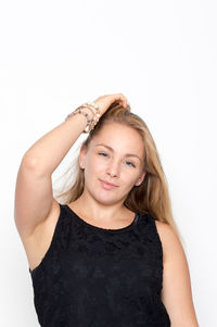 Portrait of smiling young woman against white background