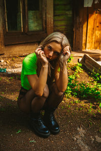 Young woman sitting outdoors