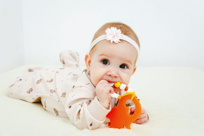 Portrait of cute baby boy against white background