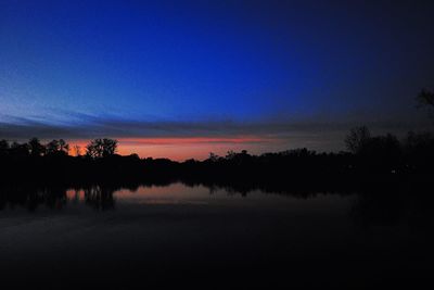 Scenic shot of calm lake at sunset