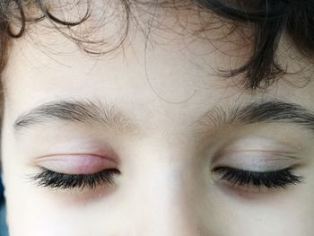 Close-up portrait of woman with eyes closed