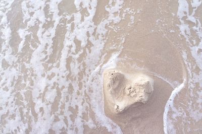 Love shape sand at beach. love, feeling, mood and broken heart concept.