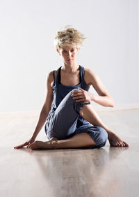 Woman doing yoga on wooden floor