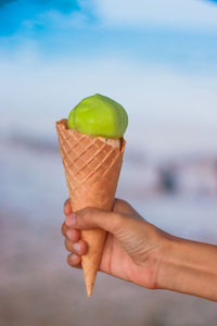 Cropped image of hand holding ice cream cone