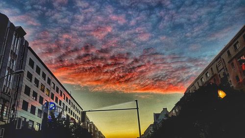 Low angle view of buildings against dramatic sky