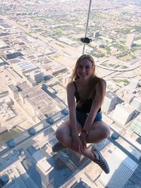 Portrait of smiling young woman in city