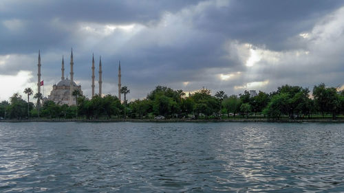 Panoramic view of buildings against cloudy sky