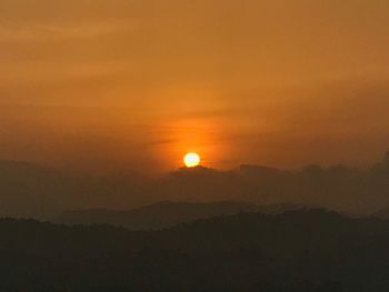 Scenic view of silhouette mountain against sky during sunset
