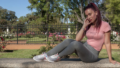 Full length of woman sitting in park