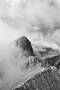 Low angle view of mountain against cloudy sky