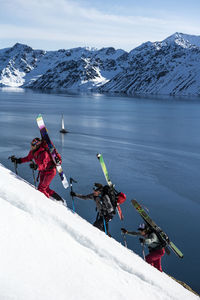 Group of friends skinning up mountain to ski in svalbard