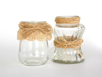 Close-up of glass jar on white background
