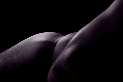 Close-up of human hand against black background