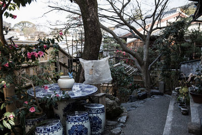 Flower vase on table by plants
