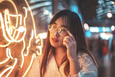 Portrait of woman with illuminated hair at night