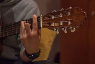 Close-up of hands playing guitar