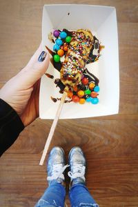 Low section of person with multi colored candies