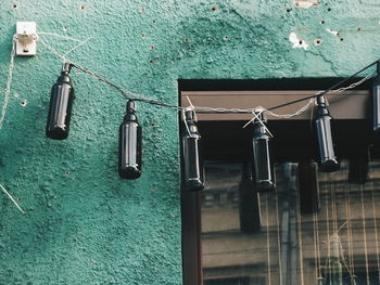 Low angle view of bottle decorations hanging outside house