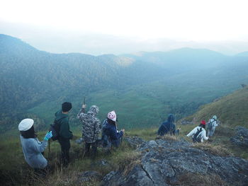 High angle view of people on mountains during foggy weather