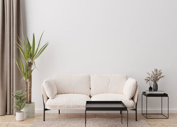 Empty white wall in modern living room. mock up interior in contemporary, scandinavian style. 