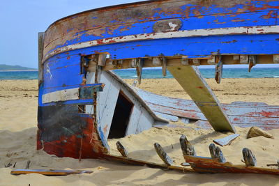 Abandoned boat against blue sky