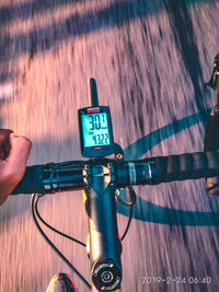 Close-up of hand riding bicycle