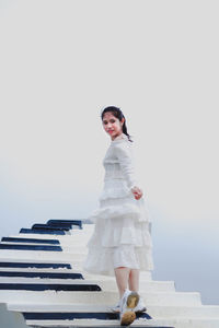 Portrait of a smiling young woman standing outdoors