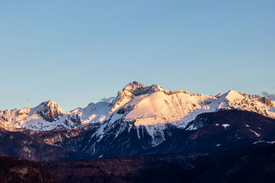 Scenic view of snowcapped mountains against clear sky