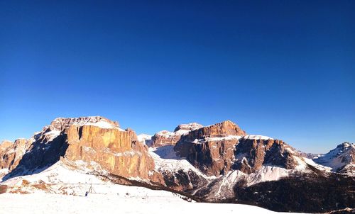 Scenic view of snowcapped mountains against clear blue sky