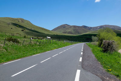 Empty road along countryside landscape