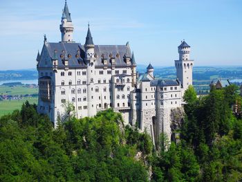 Panoramic view of buildings and trees against sky