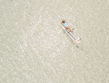 Aerial view of woman kayaking in sea