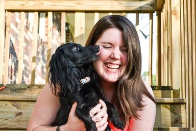 Close-up of a smiling young woman with dog