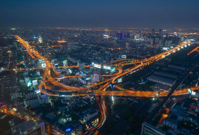 High angle view of illuminated buildings in city at night