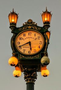 Low angle view of illuminated street light against clear sky