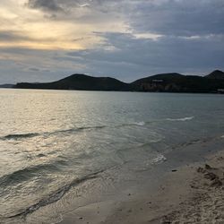 Scenic view of beach against sky during sunset