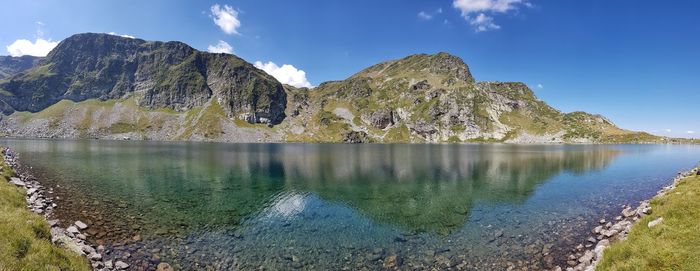 Scenic view of lake and mountains against sky