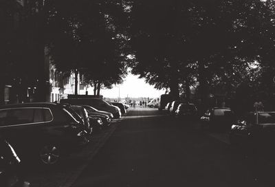 Cars on road in city against sky