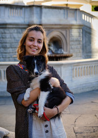 Portrait of young woman with dog