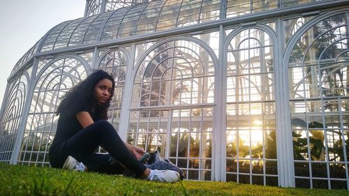 Portrait of young woman sitting outdoors