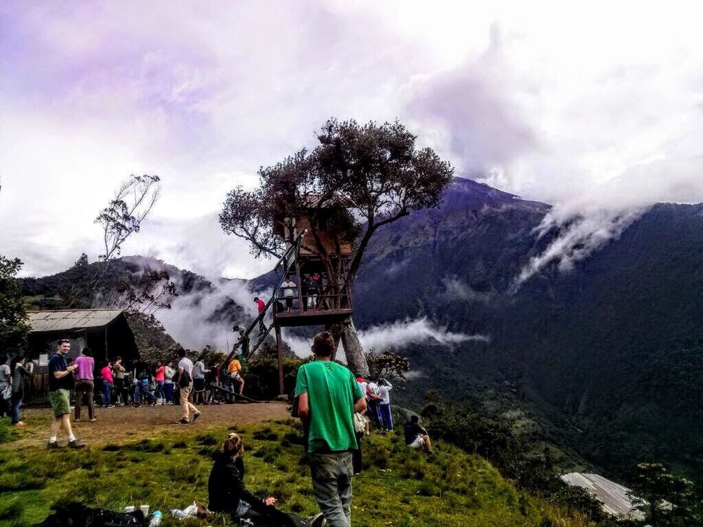 mountain, tree, sky, large group of people, lifestyles, men, person, leisure activity, cloud - sky, mountain range, tourist, built structure, architecture, landscape, weather, building exterior, tourism, religion, cloud