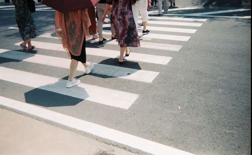 Low section of people walking on road