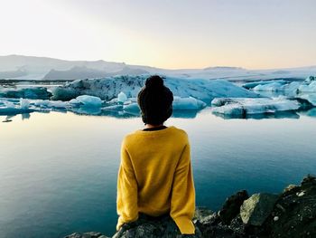 Rear view of woman looking at glaciers 