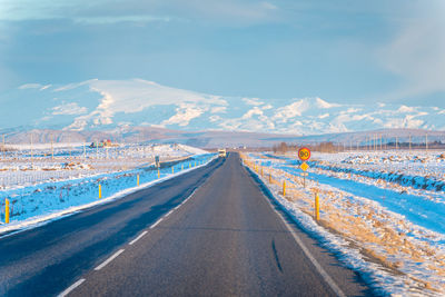 Panoramic view of road leading towards mountain against sky