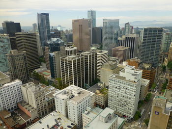 High angle view of modern buildings in city against sky