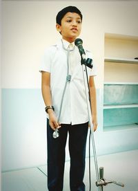 Boy in doctors costume talking on microphone