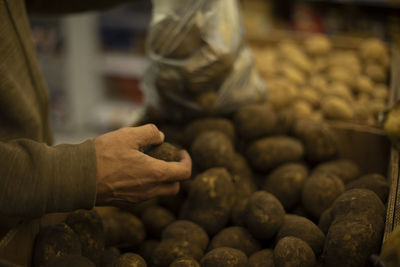 Cropped hand of man holding food