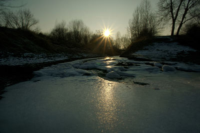 Scenic view of snow covered landscape during sunset