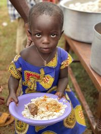 Portrait of cute girl eating food